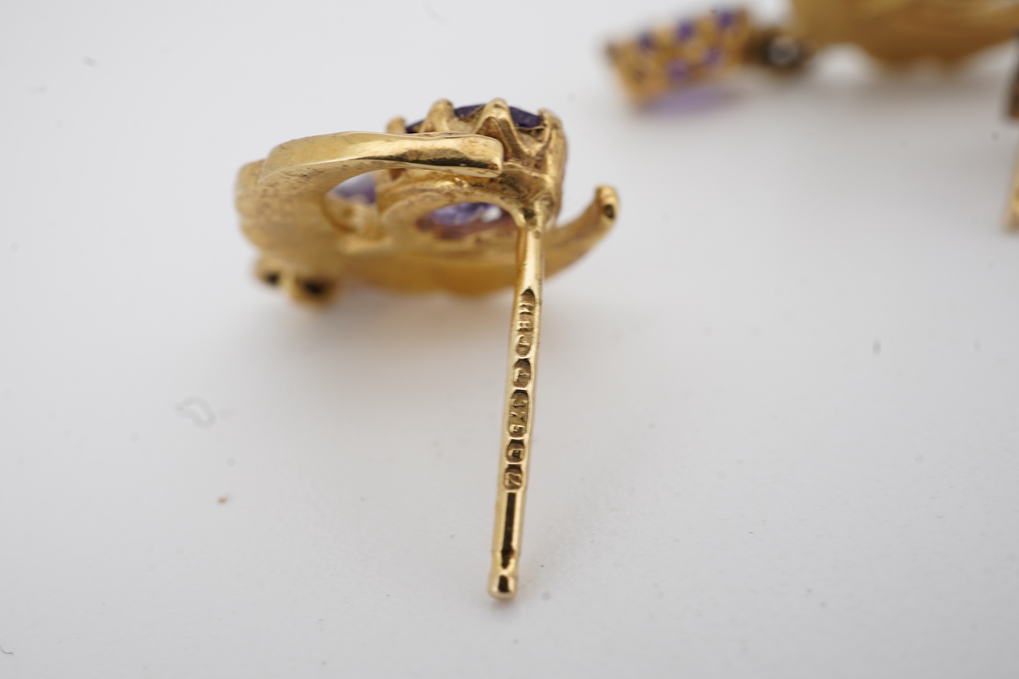 A pair of mid to late 20th century white metal, emerald and diamond cluster set drop earrings, drop 16mm, together with a pair of 9ct gold, amethyst and seed pearl set crescent drop earrings.